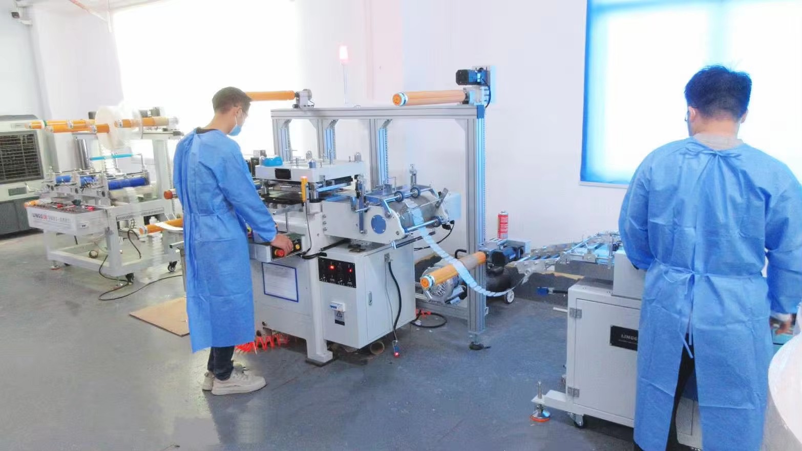 Production team operating converting equipment